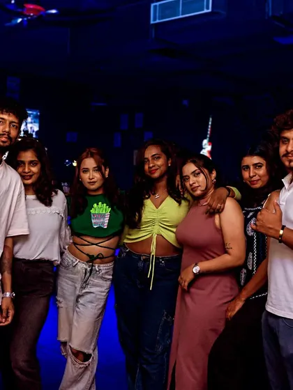 A cool group of friends hanging out by the bar.