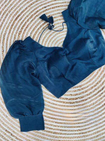 The organza blouse in a sophisticated teal blue.