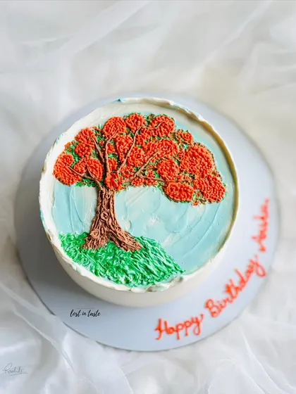 This cake is a tribute to the beautiful Gulmohar tree. The design is hand-piped with colored buttercream to create a miniature painting you can eat.