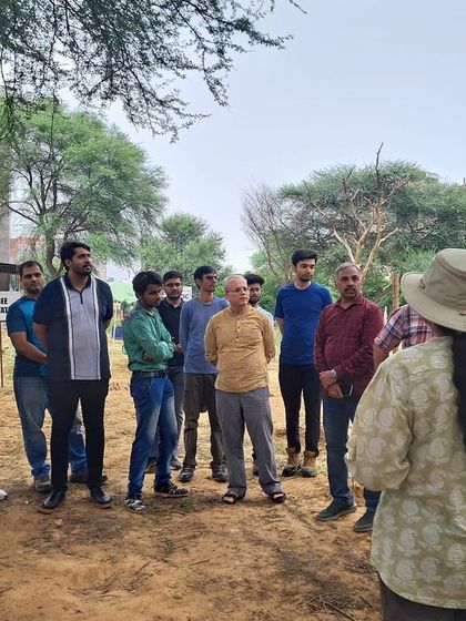 Our team briefs the Estee Advisors volunteers at Aravali Creek, explaining the ecological importance of the site before the plantation begins.