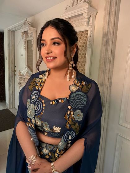 A candid shot of this artistic makeup and hair look. The messy ponytail and glowing skin are perfect for a sunny, outdoor wedding event.