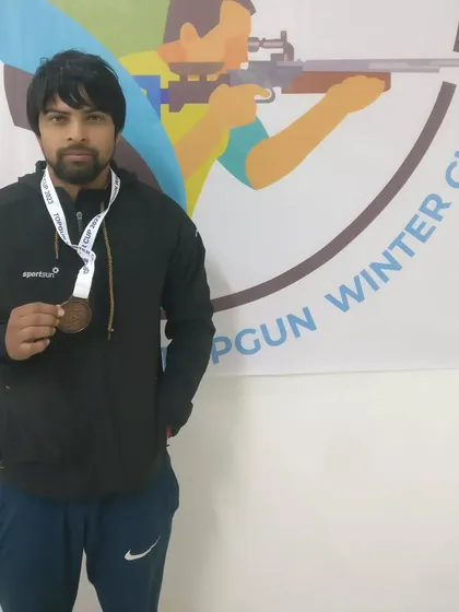 A competitor with his bronze medal from the TOPGUN WINTER CUP 2023. Every medal represents a step forward in a shooter's journey, and we celebrate every achievement.
