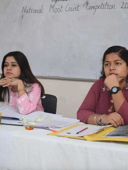 Listening intently to arguments during a moot court round. My role as a judge is to provide constructive feedback on everything from legal reasoning to courtroom etiquette.