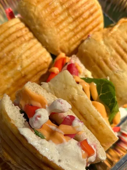 Freshly made Falafel Pita Pockets, stuffed with crispy falafel, hummus, and pickles. This is a wholesome and flavorful snack, great for brunch or high-tea catering.