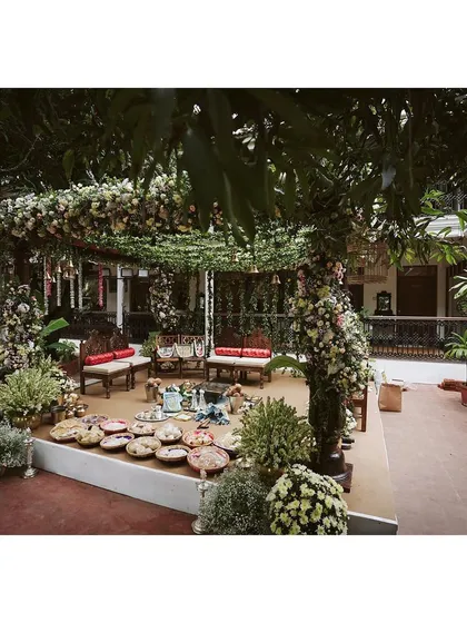 A wider view of the Chettinad-inspired mandap, designed to blend seamlessly with the venue's natural trees and foliage.