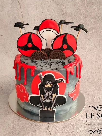 For all the anime fans, here's an Itachi Uchiha cake that was so much fun to design. This Milk & Cookies cake features a 2D fondant Itachi, his Sharingan, and a dramatic red and grey buttercream finish with a blood-drip effect.