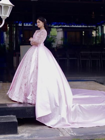 This shot captures the dramatic elegance of the pink gown's long train. It's a perfect choice for a bride who wants a truly memorable entrance.