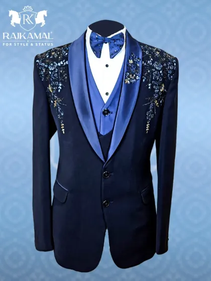 For a reception or cocktail evening, I designed this navy blue tuxedo to be a showstopper. It features a satin lapel and exquisite floral beadwork on the shoulders, offering a sharp, modern silhouette with a touch of regal flair.