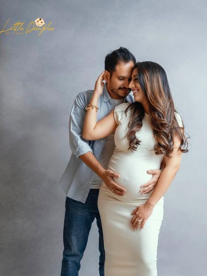 A timeless studio portrait of an expecting couple. The soft, diffused light and their gentle embrace create a serene and loving mood.