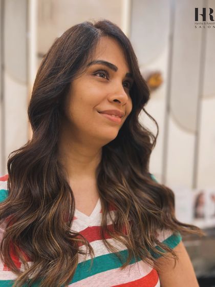 A smiling client, thrilled with her new dimensional hair color.