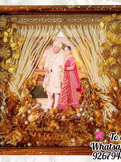 This stunning frame preserves a bride's kalgi, sehra, and varmala flowers. The golden accessories and flowers are arranged to create a beautiful and balanced composition.