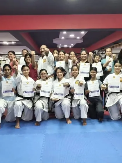 A group of empowered participants proudly holding their certificates after completing a women's self-defense workshop at my Honbu Dojo. This moment represents not just new skills learned, but a significant boost in confidence.