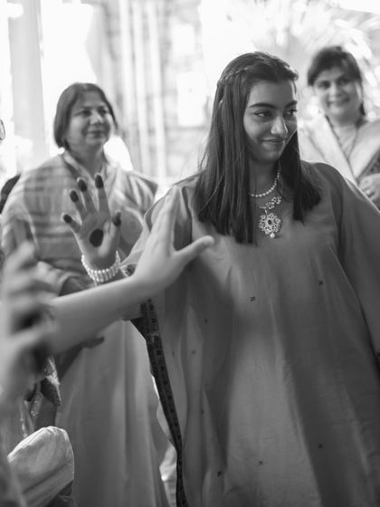 A candid, black and white shot of the co-founder wearing the upcycled kaftan. It captures the effortless grace of an outfit that is both modern in silhouette and rich in personal history.