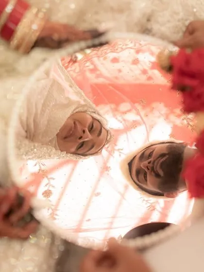 The 'Aarsi Mushaf' is one of the most beautiful rituals in a Muslim Nikkah, where the couple sees each other for the first time as husband and wife in a mirror. I used a creative angle to capture their reflections, a symbol of their new shared life.