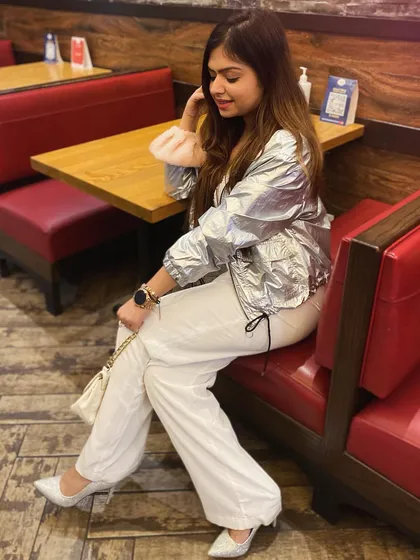 A cool, futuristic look with a silver jacket and white wide-leg pants.