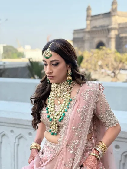 A classic and regal look for a wedding celebration at the Taj Mahal Palace. I created a soft glam look with defined eyes and a neutral lip to complement her intricate blush pink lehenga and emerald jewelry.