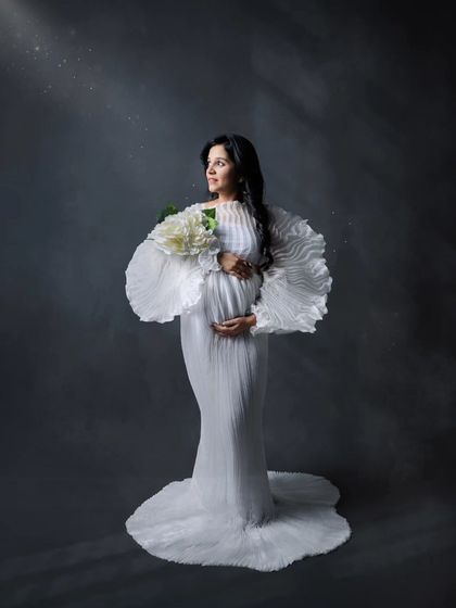 Looking towards the future with hope and joy. This artistic maternity portrait uses light and shadow to create a truly memorable image.