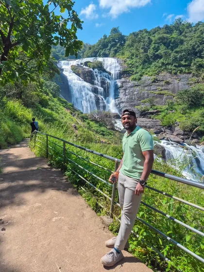 Posing by the trail with the stunning Mallalli Falls in the background.