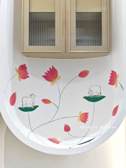 The completed Pichwai-inspired mural in a minimalist office mandir. The design features sacred cows and lotus flowers with gold detailing to match the classy, understated interior.