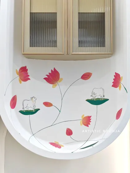 The completed minimalist Pichwai painting in an office mandir. The clean design with delicate cows and lotuses adds a touch of spiritual elegance to the corporate environment.