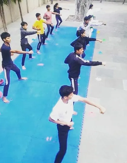 A high-angle view of an outdoor training session. You can see the entire class practicing their punches in unison, a testament to the discipline and focus I instill in every student.