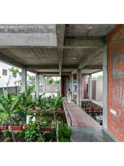 The ground floor of the ASA office, which we transformed into a wetland and public space. A raised brick walkway meanders through the plants and water, creating a cool, welcoming entrance that naturally manages stormwater.