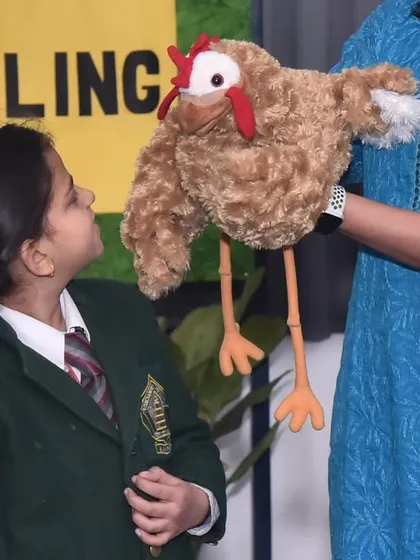 A student from Puranchandra Vidyaniketan, Kanpur, gets a one-on-one interaction with Paprika the chicken. It's a great way to make the experience personal and memorable.