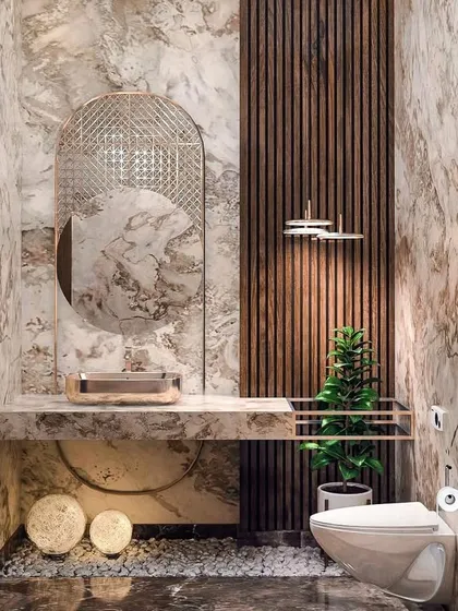 This bathroom design blends natural and refined materials. The combination of book-matched marble walls, a fluted wood accent panel, and a pebble-filled floor detail creates a spa-like atmosphere that feels both organic and luxurious.