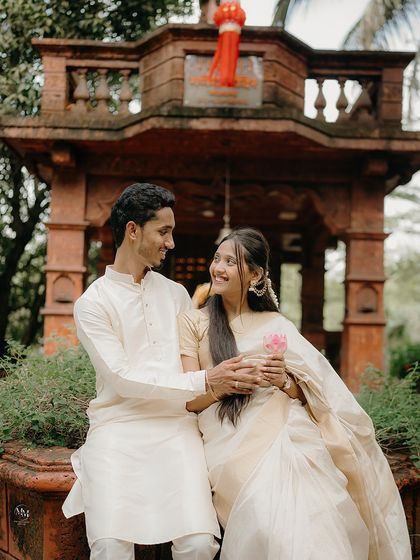 Sharing a quiet moment of connection. Seated together in a traditional setting, their smiles reflect the comfort and happiness they find in each other's company.