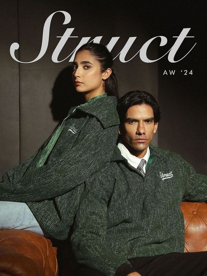 A campaign image for Struct's Tweed Sailor Pullover, featuring both male and female models for a unisex appeal.