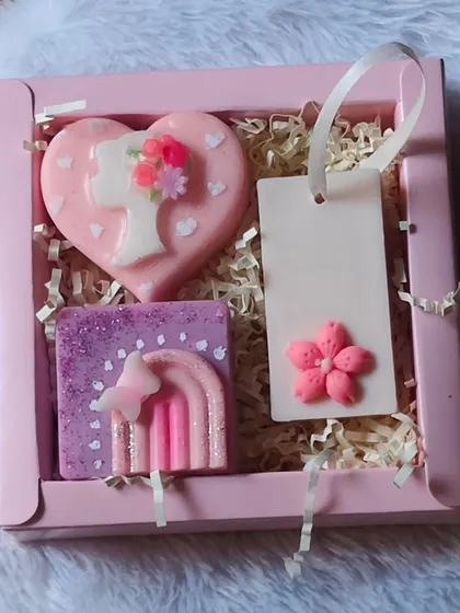 A Women's Day hamper featuring a heart-shaped "lady" soap, a rainbow soap, and a wardrobe freshener, all in a lovely pink box.