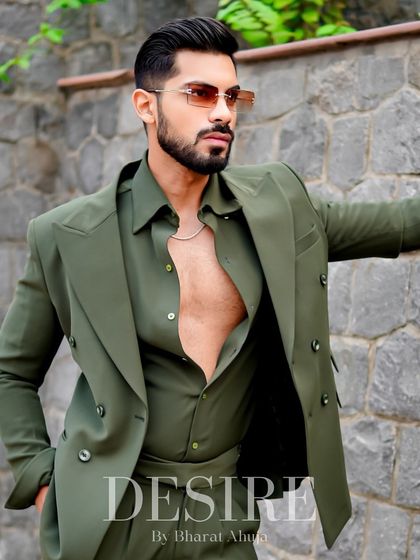 Another take on the unbuttoned olive green suit, showcasing its versatility and the confident attitude it projects.