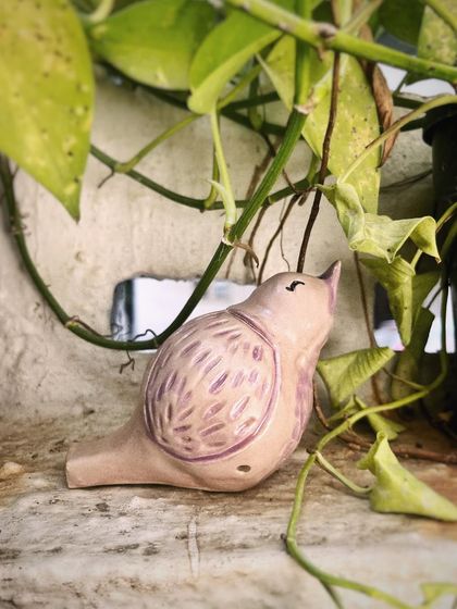 Each pajarito is hand-sculpted, so no two are ever exactly alike. This one has a particularly gentle and curious look.