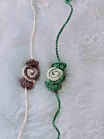 Earthy and elegant, these two-toned rose rakhis in brown and green are a unique, subtle option for Raksha Bandhan.