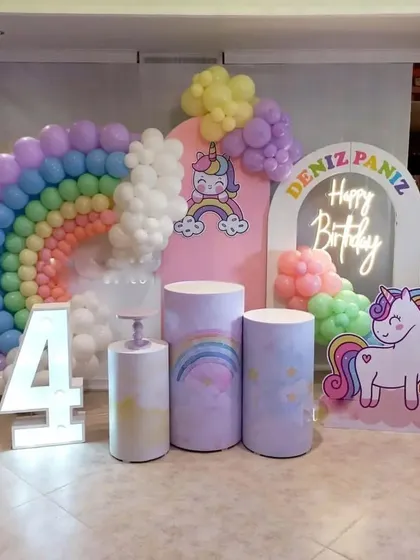 A duplicate of the unicorn and rainbow 4th birthday setup, showing the complete arrangement with props and backdrops.