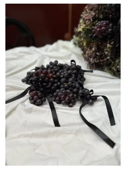 An evening wrapped in deep hues of plums and grapes, with black ribbons adding a chic, modern touch to the tablescape.