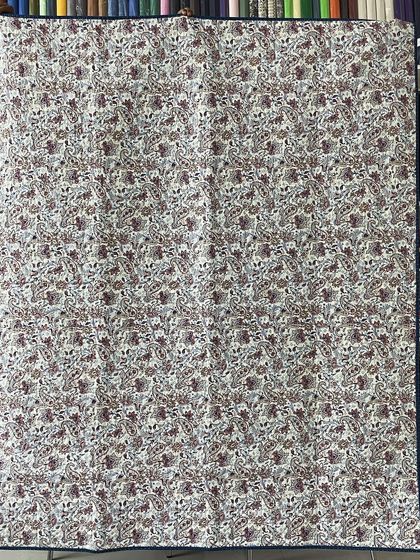 The back of the Lone Star quilt, featuring a delicate floral print.