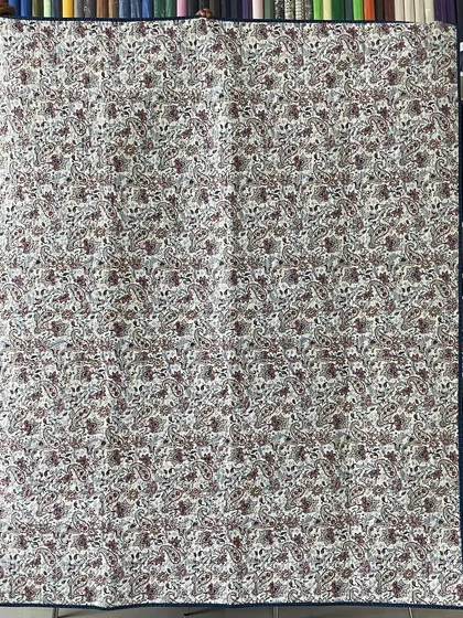 The back of the Lone Star quilt, featuring a delicate floral print.