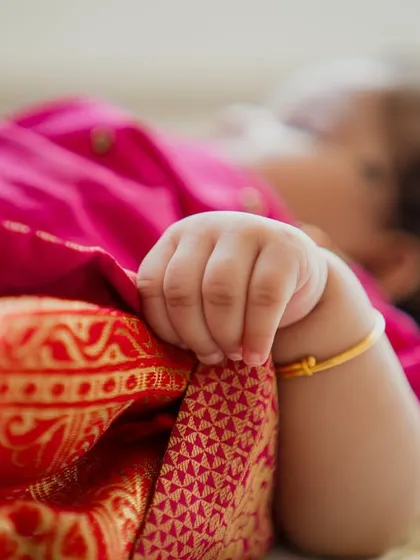 Details are my specialty. The tiny grip of a baby’s hand on a traditional silk cloth tells a story of its own, a memory of just how small they once were.