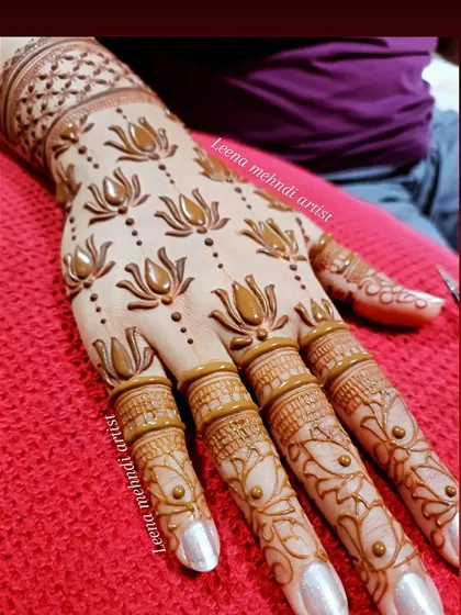 A close-up of the lotus pattern being applied. The clean lines and consistent spacing create a very polished look.