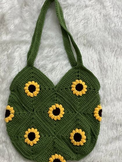 This is my sunflower granny square tote bag in a beautiful olive green. It's a spacious and eye-catching bag, perfect for carrying your daily essentials.