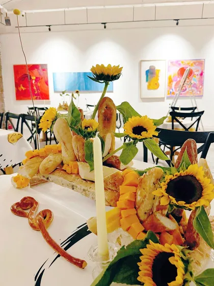 The full tablescape, a feast for both the eyes and the palate, perfectly complementing the art gallery setting.