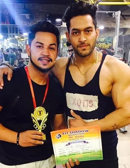 Posing with my client and his trophy from a Mr. Delhi competition. This is what my contest prep service is all about: getting you in the best shape of your life and ready to win titles.