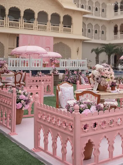 The 'Pink Jaipuri Bagh' mehendi featured distinct seating areas enclosed by custom-made pink jali fences, creating intimate and picturesque spaces.