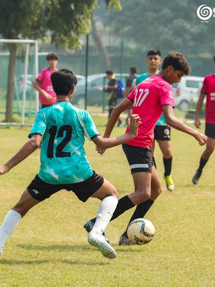 An intense midfield battle as two players from GSC and Manav Rachna vie for possession.