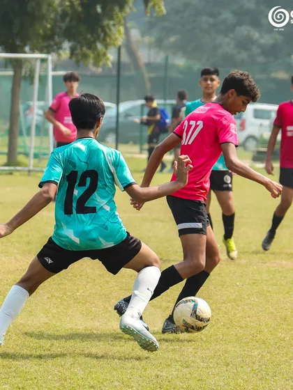 An intense midfield battle as two players from GSC and Manav Rachna vie for possession.