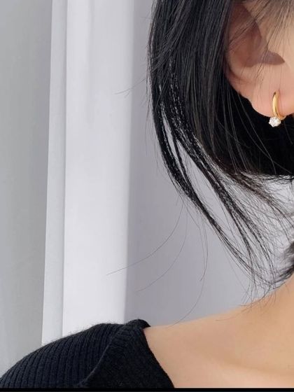 A closer look at my crystal hoop earrings. The small, sparkling stone dangles freely, catching the light as you move.