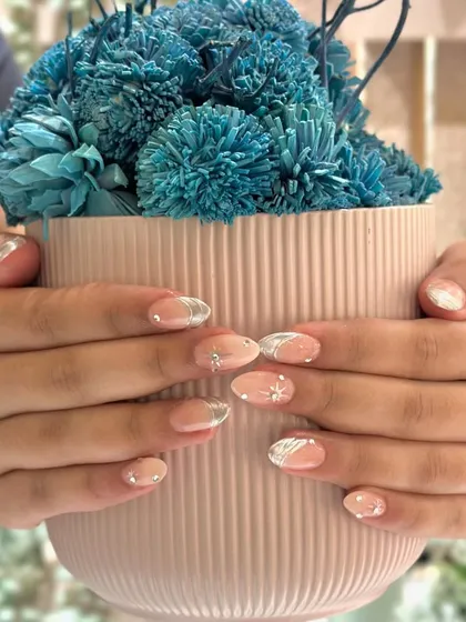 Another look at our popular chrome French manicure, this time with delicate star and swirl details for a touch of whimsy.