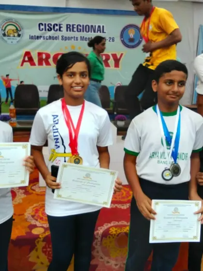 A group of our young champions posing with their medals and certificates. We train archers to compete and succeed in various age and skill categories.