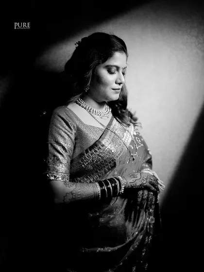 We believe a portrait should be more than just a picture; it should be a piece of art. Using dramatic light and shadow, we created this timeless black and white portrait of the bride, capturing her grace and poise.